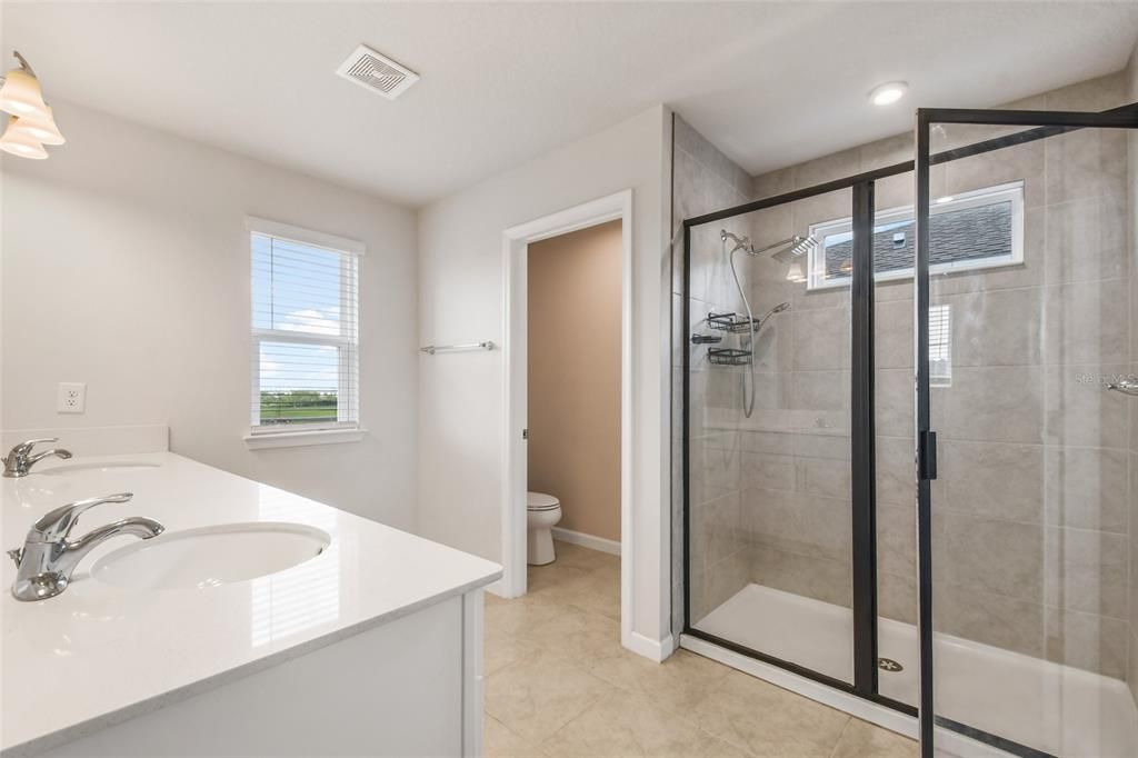 The Owner's Bathroom with double sinks, a walk in shower and separate water closet.