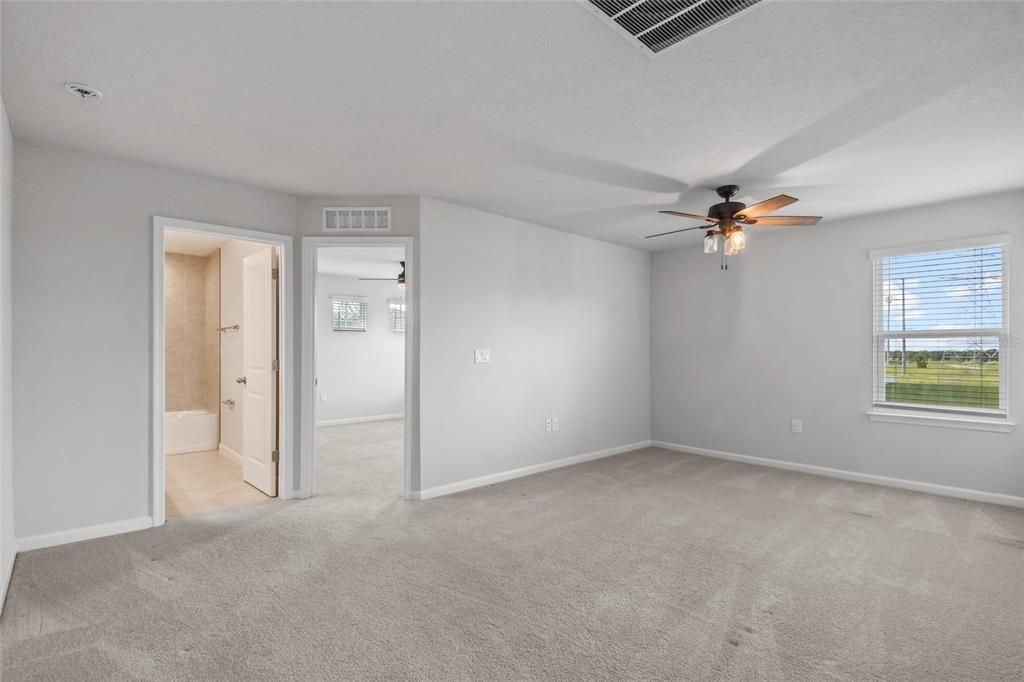 A different view of the loft space looking towards one of the guest bedrooms and the full bath.