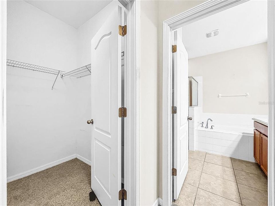 Primary  closet/ bath entry way