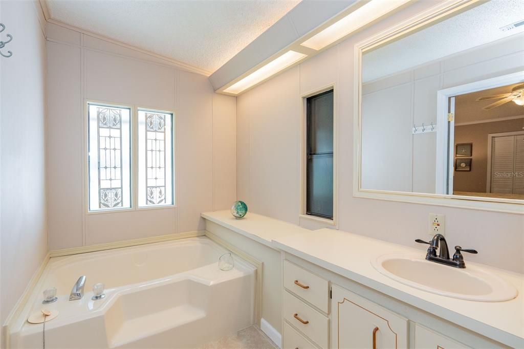 Roomy primary bathroom with separate tub and shower at 6339 Partridge Ave. Englewood FL 34224