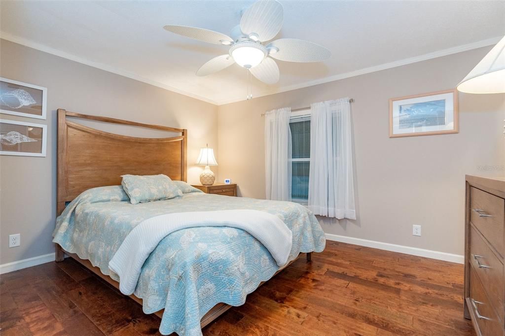 Guest bedroom with a walk-in closet and standard closet, ceiling fan and beautiful flooring at 6339 Partridge Ave. Englewood FL 34224