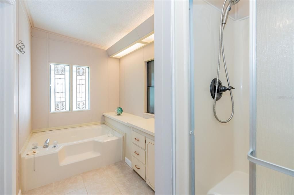 Roomy primary bathroom with separate tub and shower at 6339 Partridge Ave. Englewood FL 34224