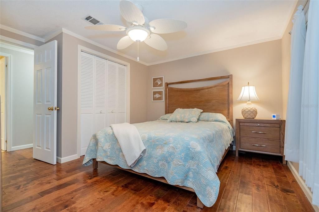 Guest bedroom with a walk-in closet and standard closet, ceiling fan and beautiful flooring at 6339 Partridge Ave. Englewood FL 34224