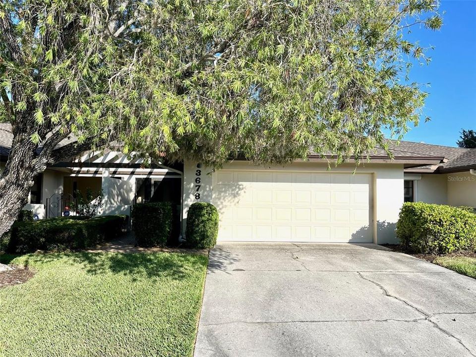 Front view. 2-car garage with walk way to the left.