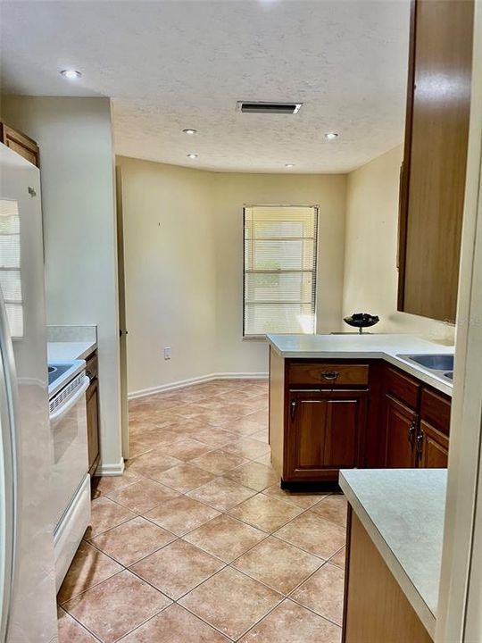 Roomy kitchen plus breakfast nook, with a window view of the front entry