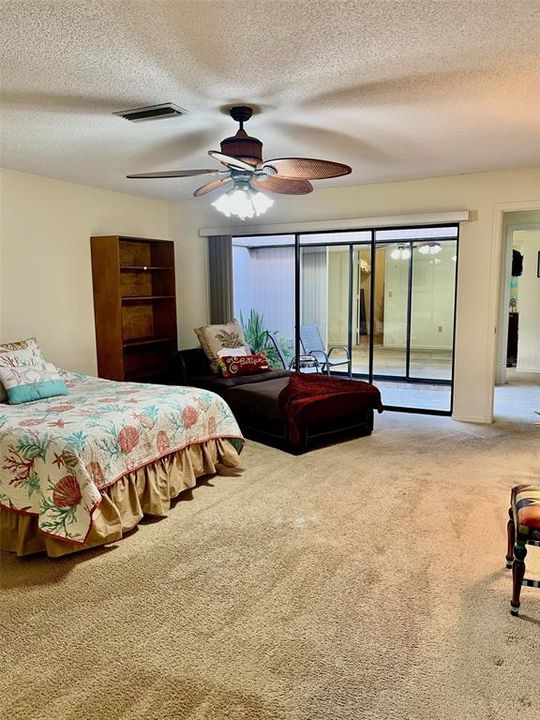 Very large primary bedroom has space for 2 queen beds. Lots of light from the atrium.