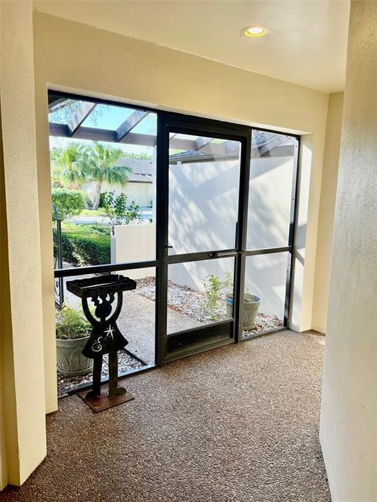 Screened front entry, nice for sitting or just letting the breeze blow through on a nice day.