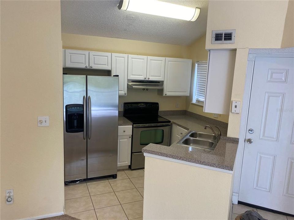 Kitchen and breakfast bar and Laundry Closet.