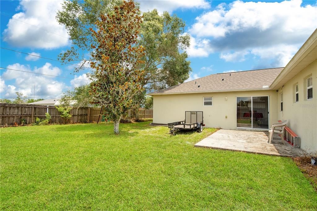 fenced backyard with concrete pad