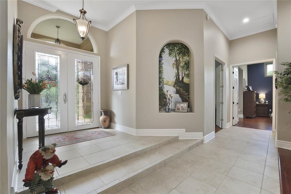 Living Room as you enter with views of the pool and upgraded landscaping.