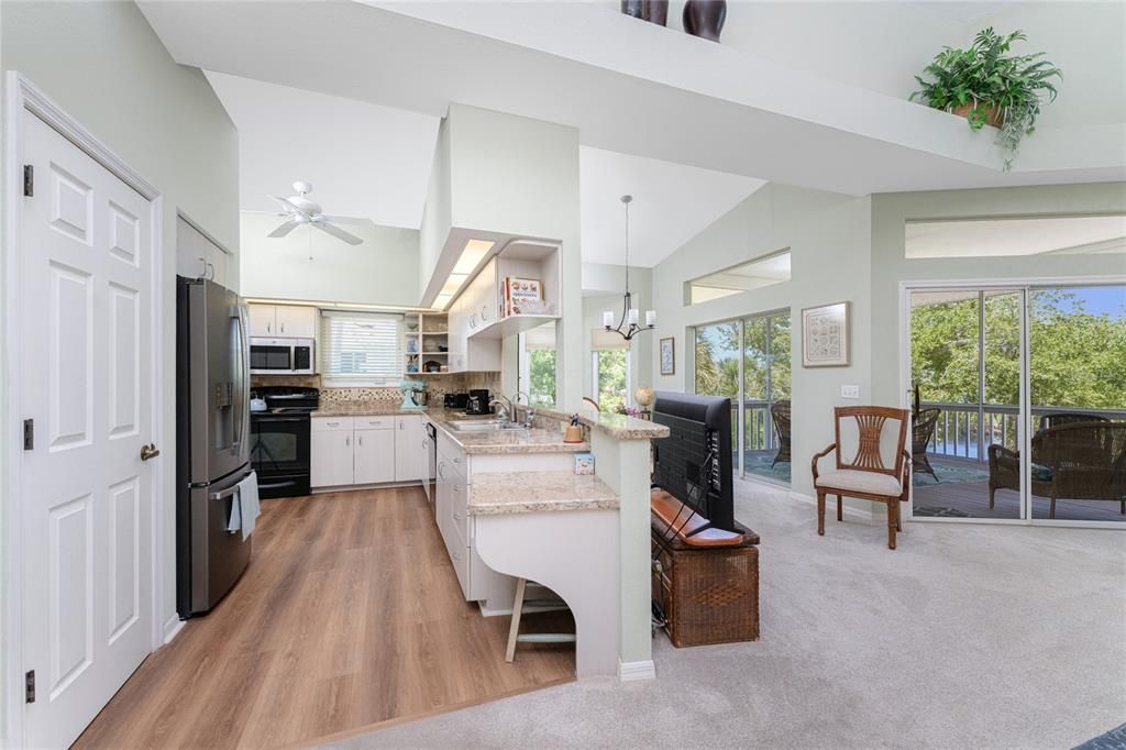 The kitchen features wood laminate flooring, ceiling fan, and beautiful counter tops.