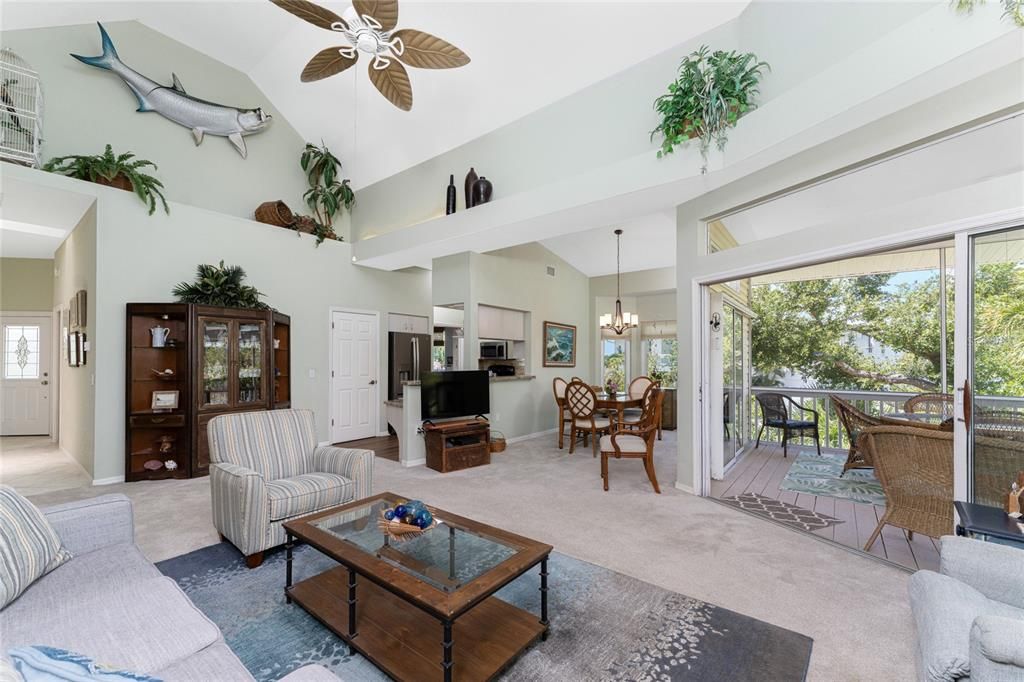 The Living Room features carpeted flooring, cathedral ceiling, and ceiling fan.