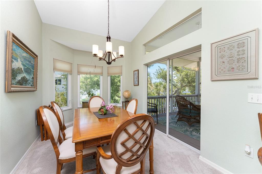 The carpeted dining area also has a fixed architectural window above the sliding glass doors.