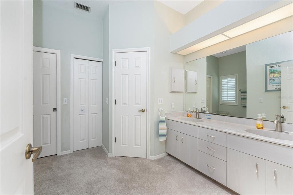 Master bath has a double basin vanity, skylight, and linen closet.