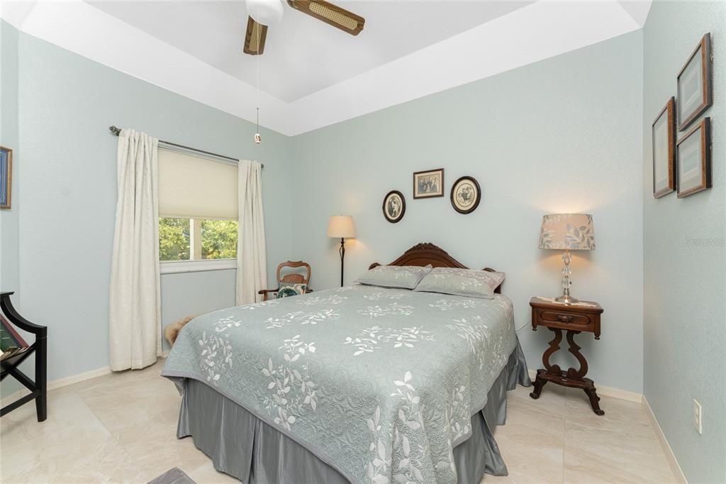 Guest Bedroom #2 has carpeted flooring, tray ceiling and ceiling fan.