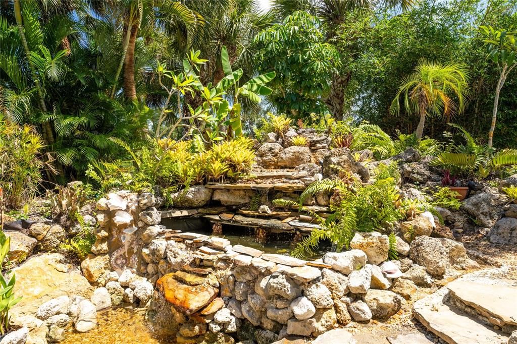 The backyard also features a beautiful landscaped fish pond.