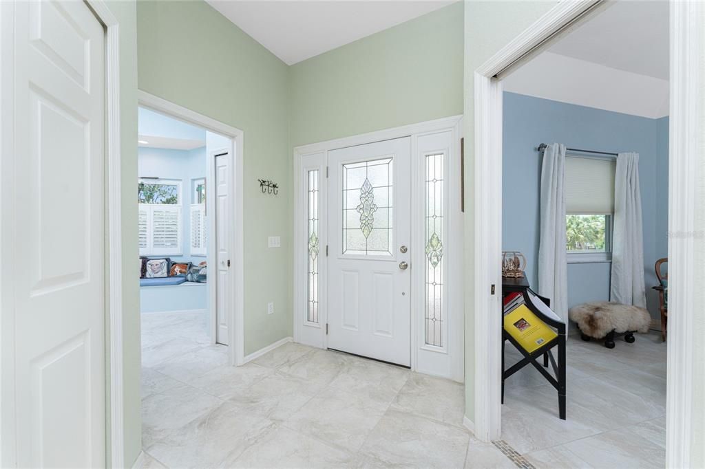 The leaded glass front door, with double sidelights, leads into the tiled front foyer.