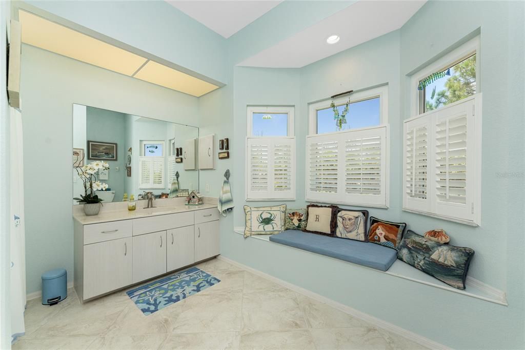 The guest bath is located across the hall from bedroom #2 with an adorable window bench.