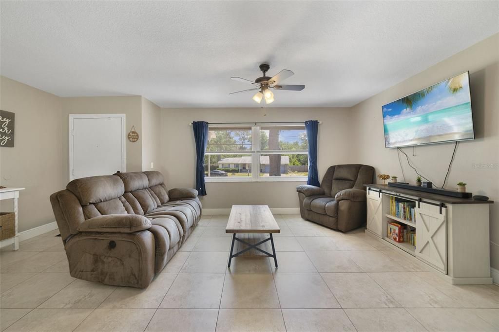 Step through the front door and into a bright and open great room, your living, dining and kitchen all flow with easy care tile floors and large windows for great natural light!