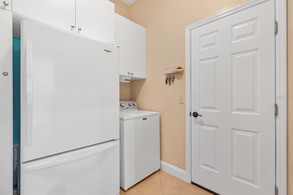 Indoor Laundry with Fridge and Built in Cabinets