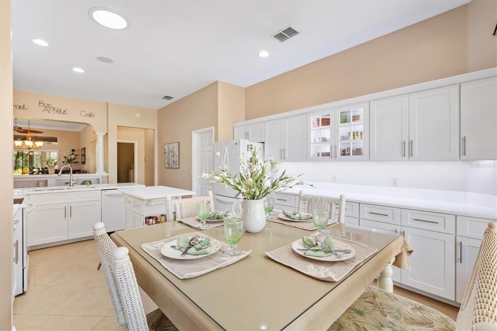 View of the kitchen nook and large kitchen area and countertops.