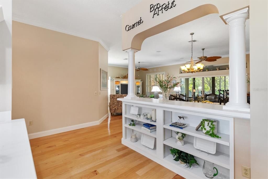 Built in shelving between the kitchen and dining room.