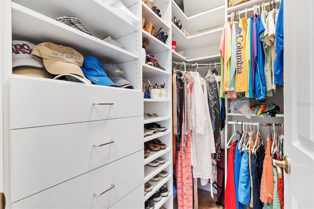 Two walk in closets with custom built-ins.