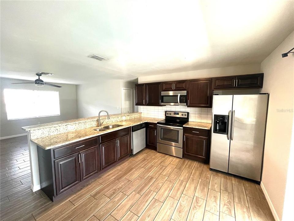 Kitchen looking toward living room and breakfast bar counter.