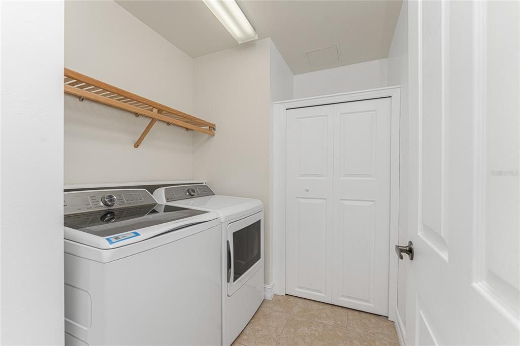 Laundry room with closet