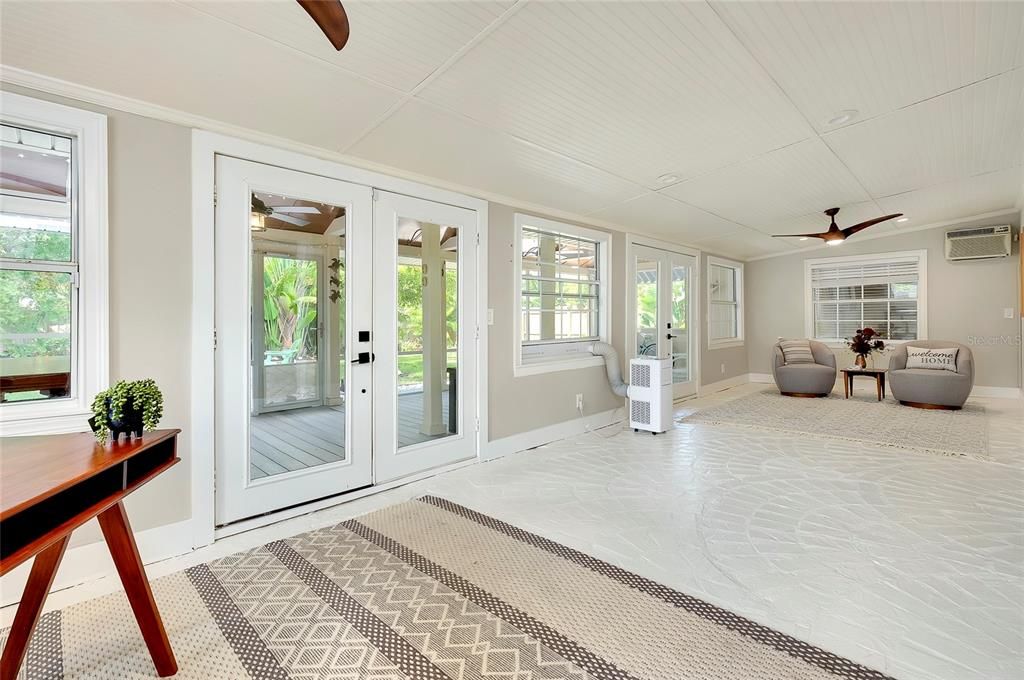 Expansive Florida room with French doors leading to the screened in porch. Great for your office or entertainment area.