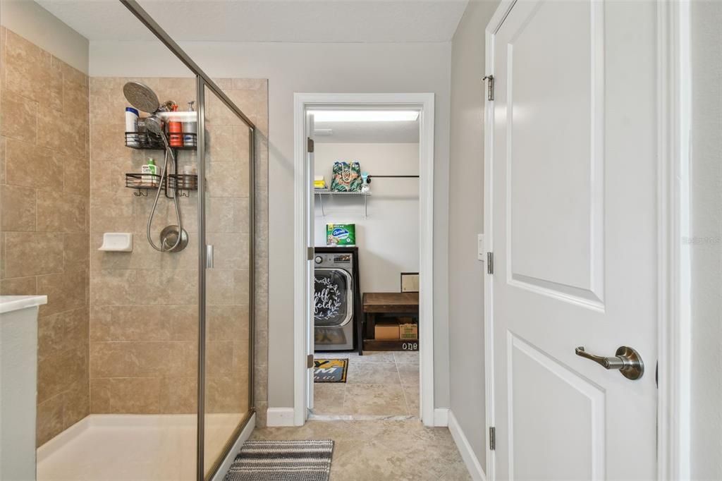 Separate shower with door to laundry room
