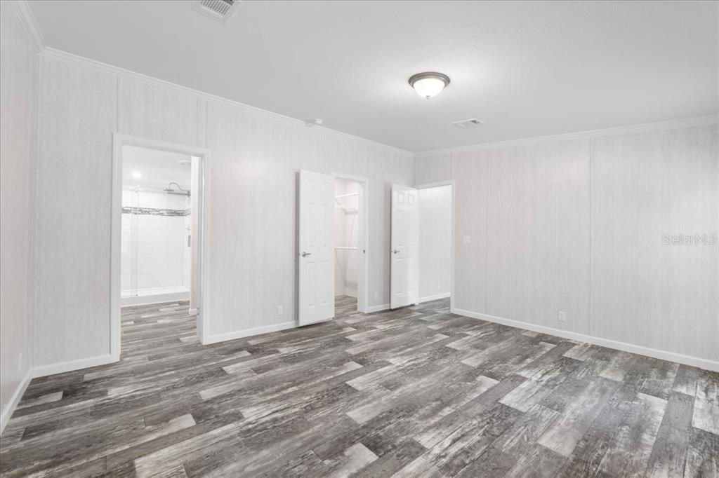 Primary Bedroom w/view of En-Suite & Walk-In Closet Entry