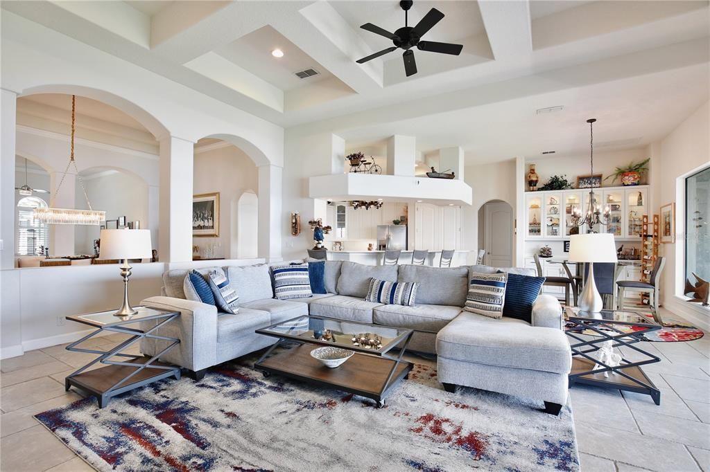 (24'X18') Family Room with coffered ceilings, gas fireplace, pocket sliding glass doors, and bar seating.