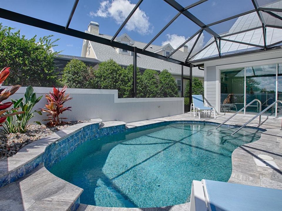 SALT WATER AND GAS HEATED POOL WITH WATERFALL AND TRAVERTINE DECKING.