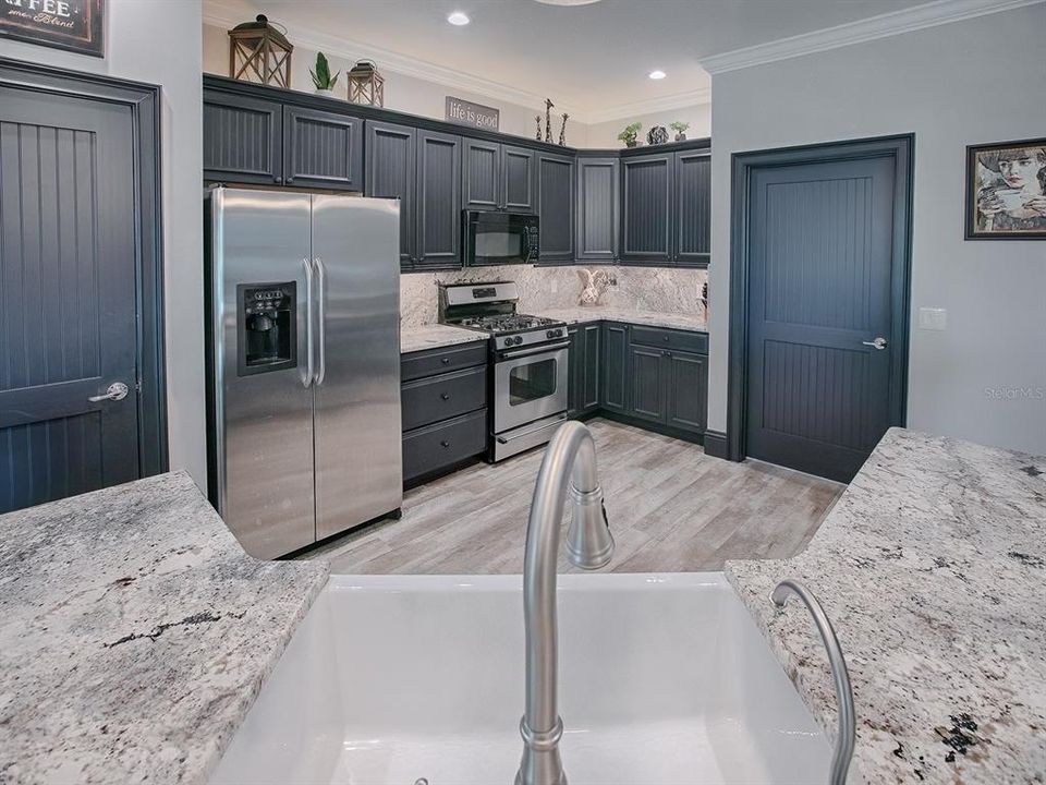 NEW GRANITE COUNTERTOPS AND BACKSPLASH. THIS DOOR LEADS TO THE LAUNDRY ROOM.