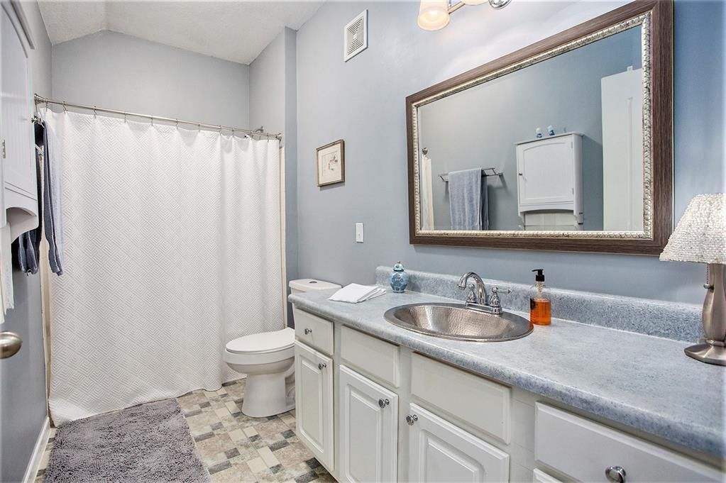 master bath with linen closet and additional cabinets