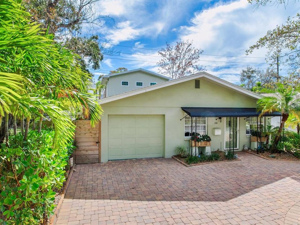 Paver circlular driveway, 2 entrances, and attached single car garage.