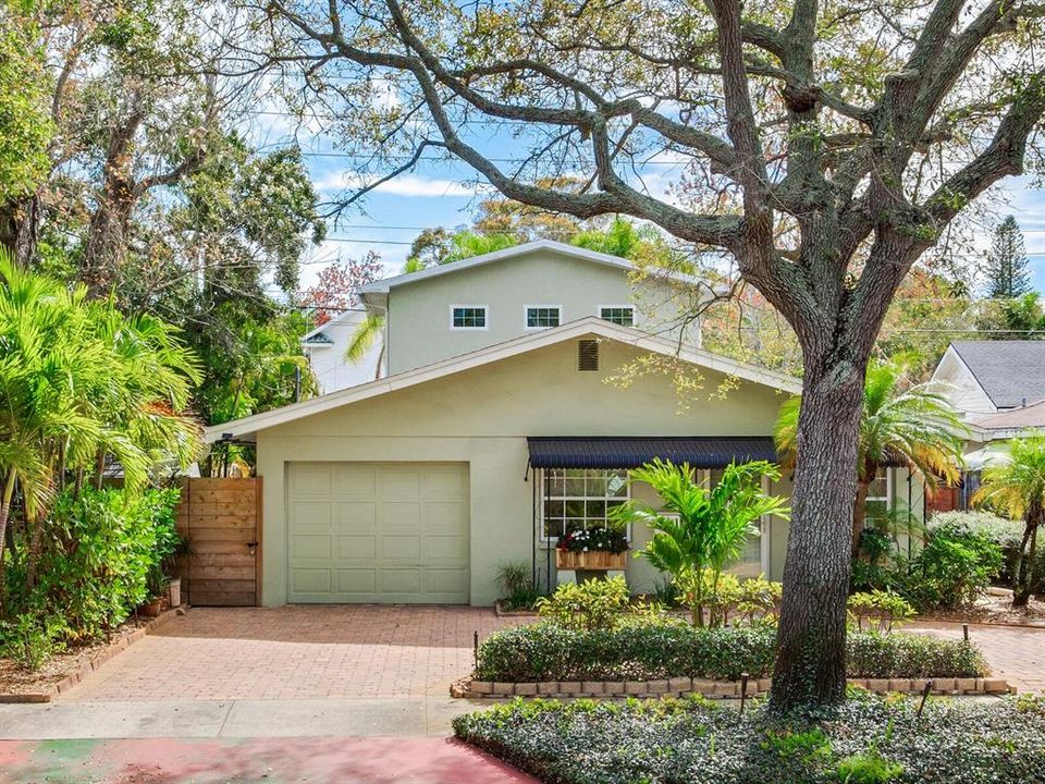 Mid Century Modern Home - updated and renovated, plus recently constructed spacoious sunroom and roomy 2nd Story Studio/3rd bedroom with full bath, kitchenette and 9' ceiling. Horizontal board wood fencing encloses the entire back of home, providing additional privacy and background for the lush garden. No lawn to mow, plus room for a pool. See photos of garden area.