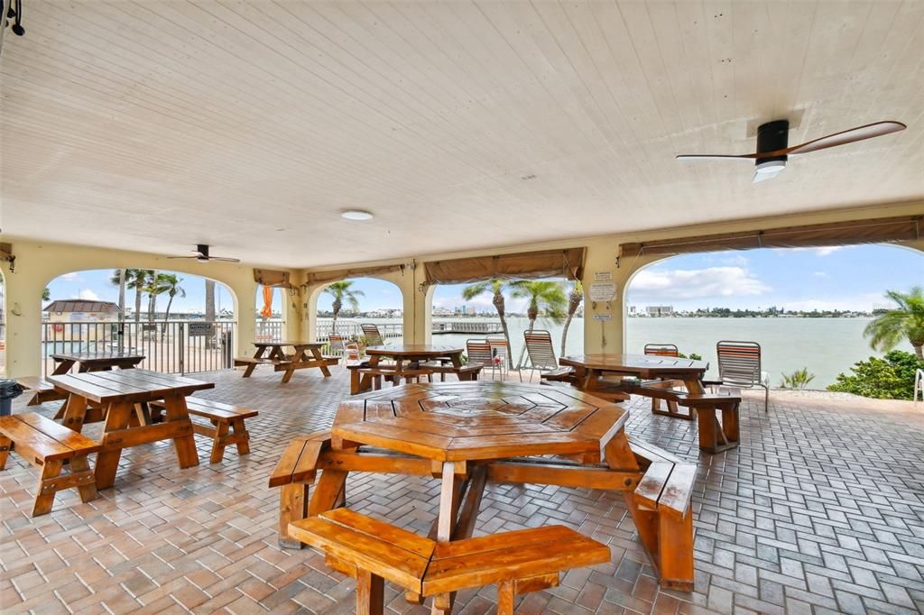 Covered tables and lounging area by Pool