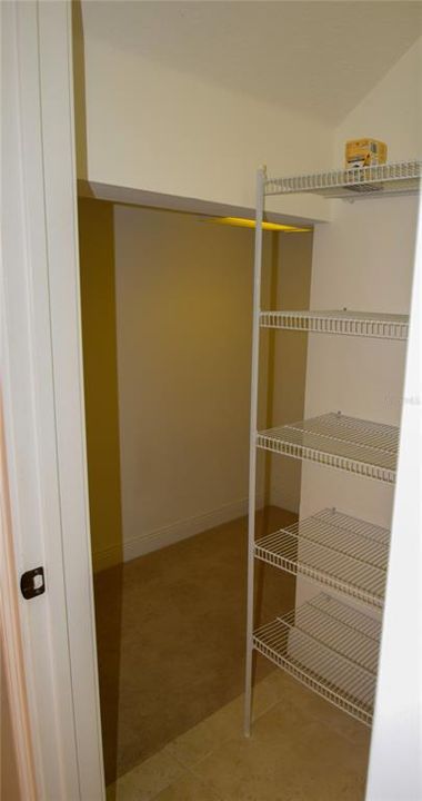 Pantry Storage Wraps Around Under Stairs