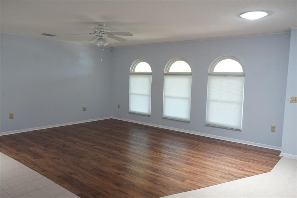 living room with bottom up shades in the windows