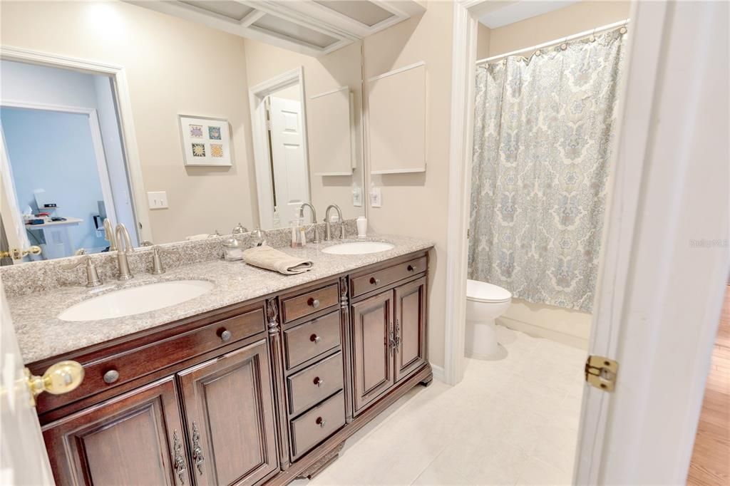 Hall bathroom with double sinks and quartz counter tops