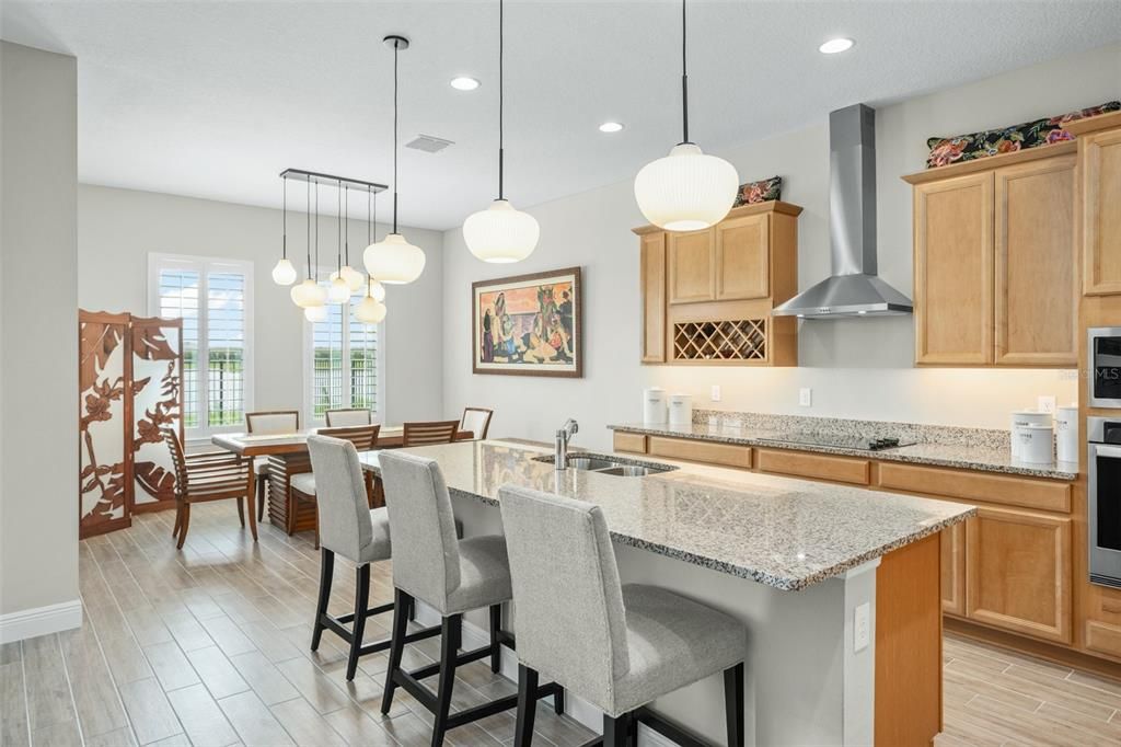 A gourmet kitchen with separate eating area overlooks the water.