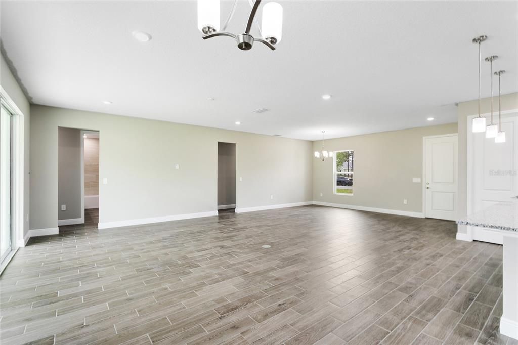 The openness of the living, dining and kitchen paired with an OVERSIZED SLIDING GLASS DOOR that accesses a COVERED LANAI makes gathering with family and entertaining friends a breeze!