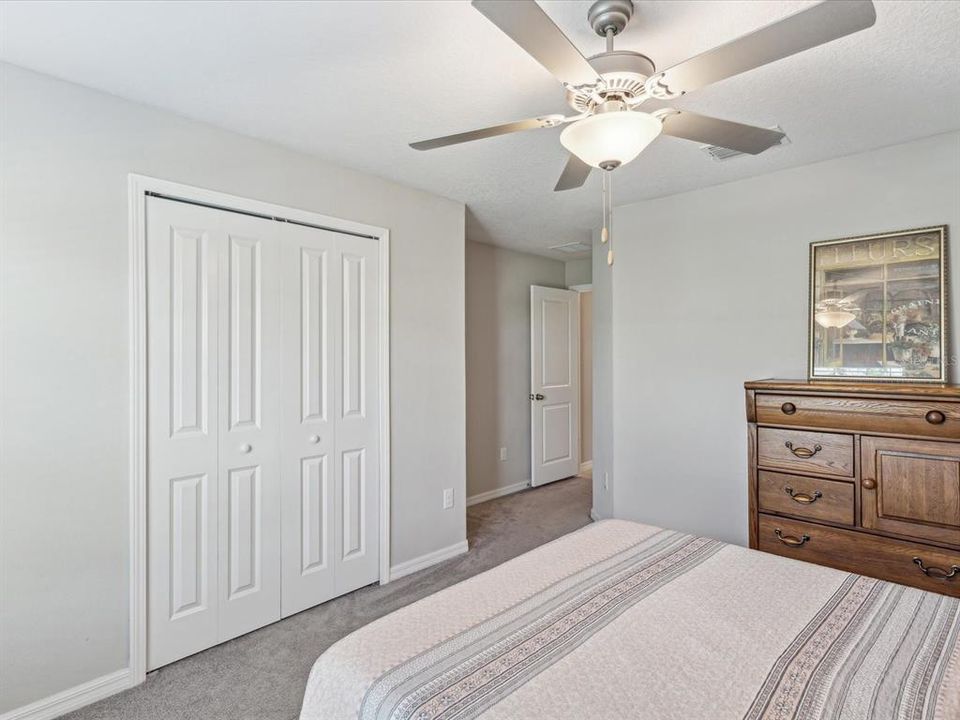 Ample sized guest bedroom with plenty of space for bedroom furniture for guests or family