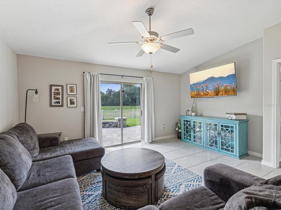 Another view of the nicely sized family room with sliding glass doors out to the rear pavered lanai overlooking a beautiful conservation view