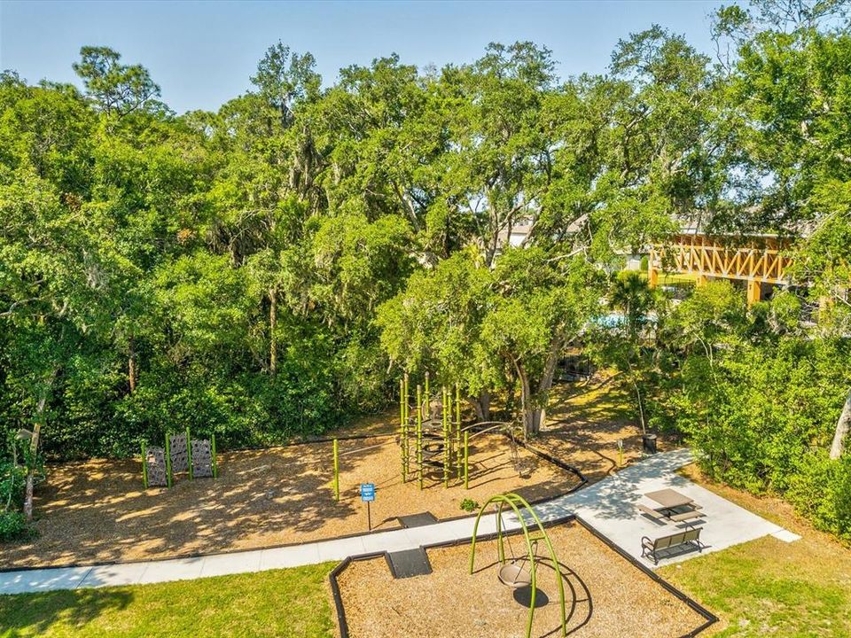 Aerial view of the community playground that sits just behind the pool and pavilion areas that are all just steps from the home