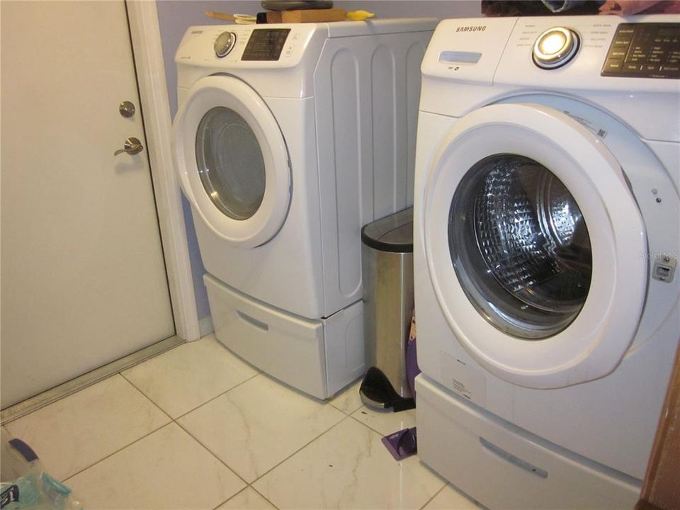 Inside Laundry Room with front load washer & dryer