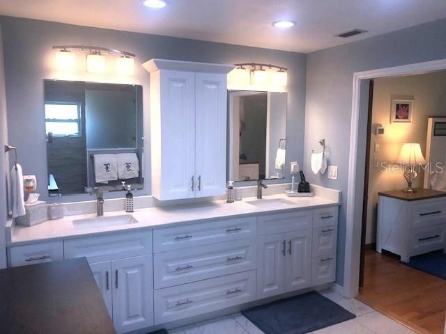 Remodeled Master Bath with dual sink, quartz top vanity, raised ceiling & more