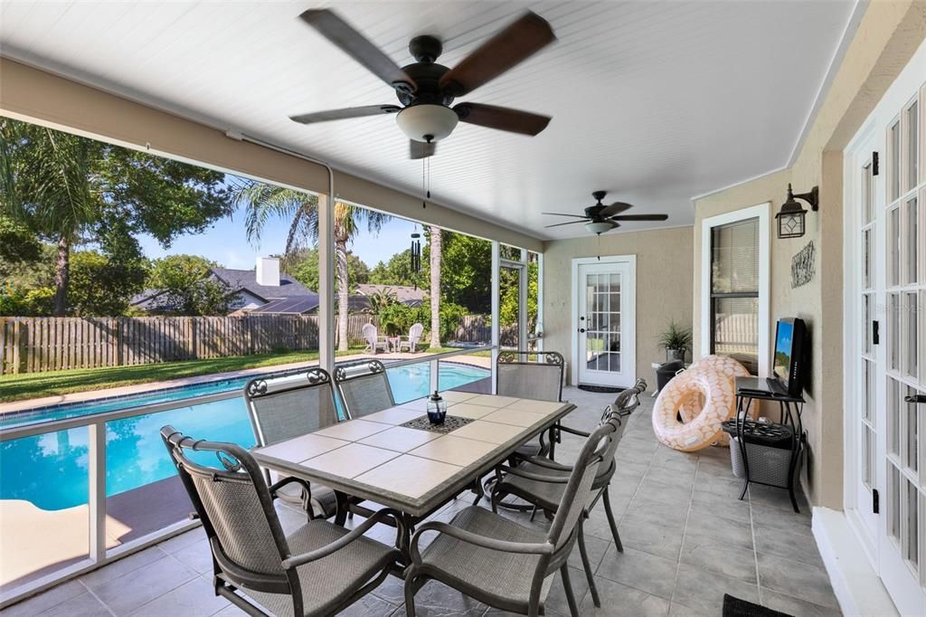 Relax in style on the screened back porch overlooking a sparkling pool and beautiful gardens.